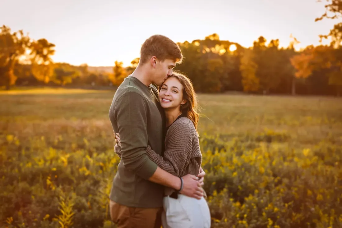 A couple standing together in an open field
