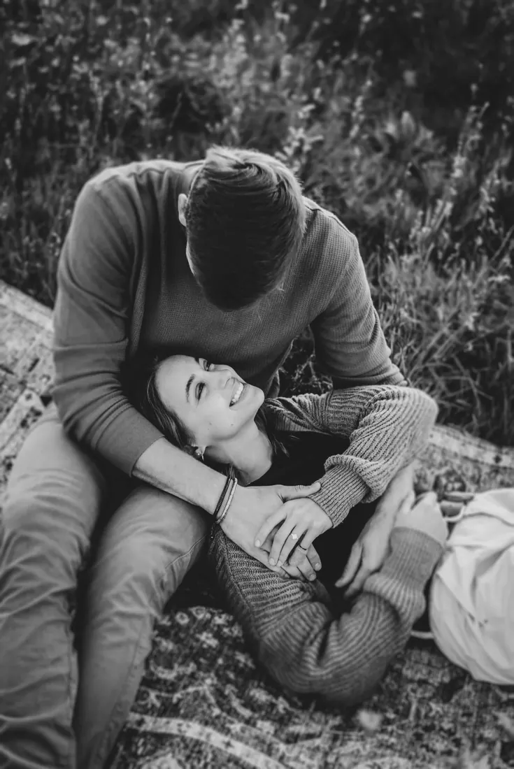 A couple lying in the grass, black and white