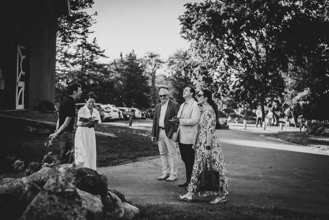 Guests at the end of a garden party, black and white