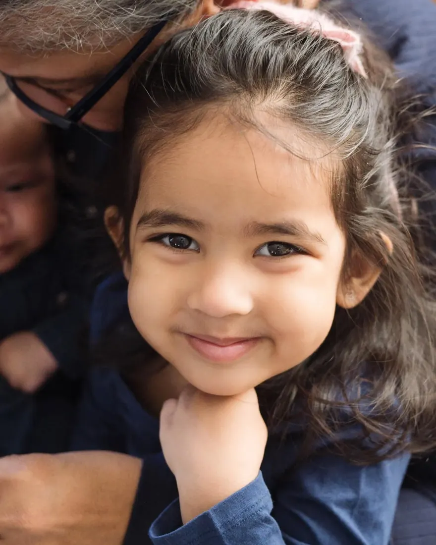 A little girl smiling close to the camera