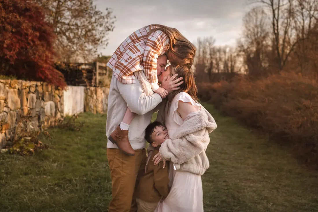 A family portrait against an autumn stone wall