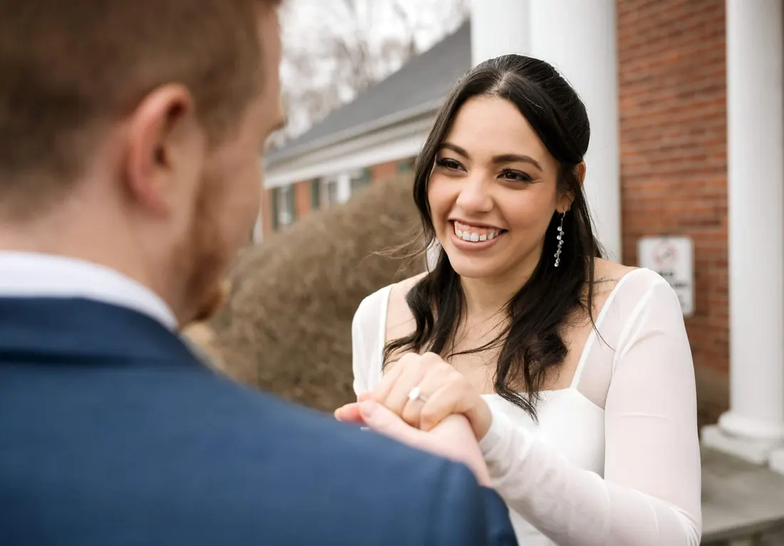 A groom kissing his bride’s hand
