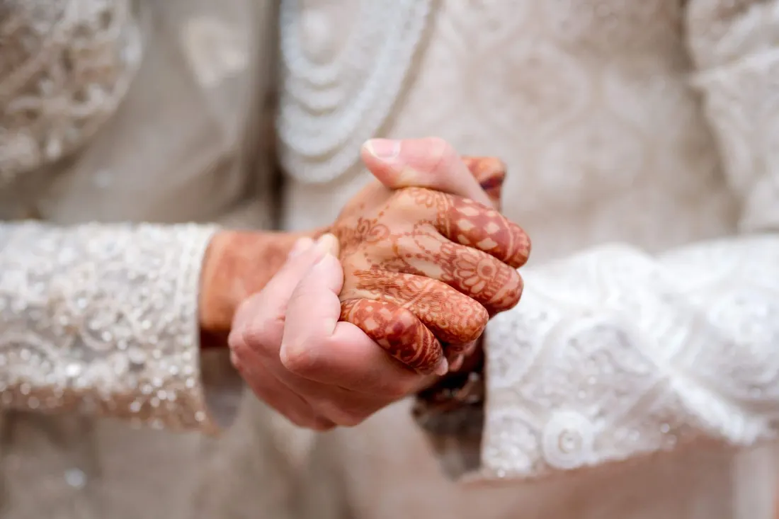 Close-up of hands decorated with henna during a wedding